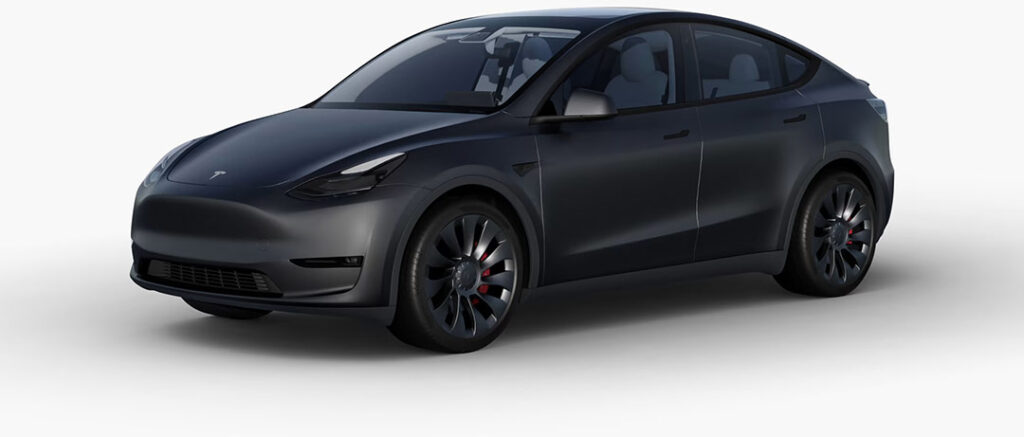 A Tesla Model Y wrapped in the OEM Satin Stealth Black color.