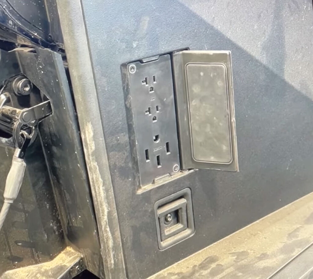 Tesla Cybertruck power outlets revealed in a spy photo. Two 110v (top) and one 220v (bottom) power sockets to insert electric equipment.