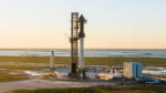 A distant view of SpaceX's Starbase orbital launch site at Boca Chica, Texas. Fully stacked Starship, the tank farm, and a separate Starship prototype are visible in the picture.