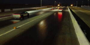 Two Tesla Cybertrucks at a drag racing strip competing against each other.