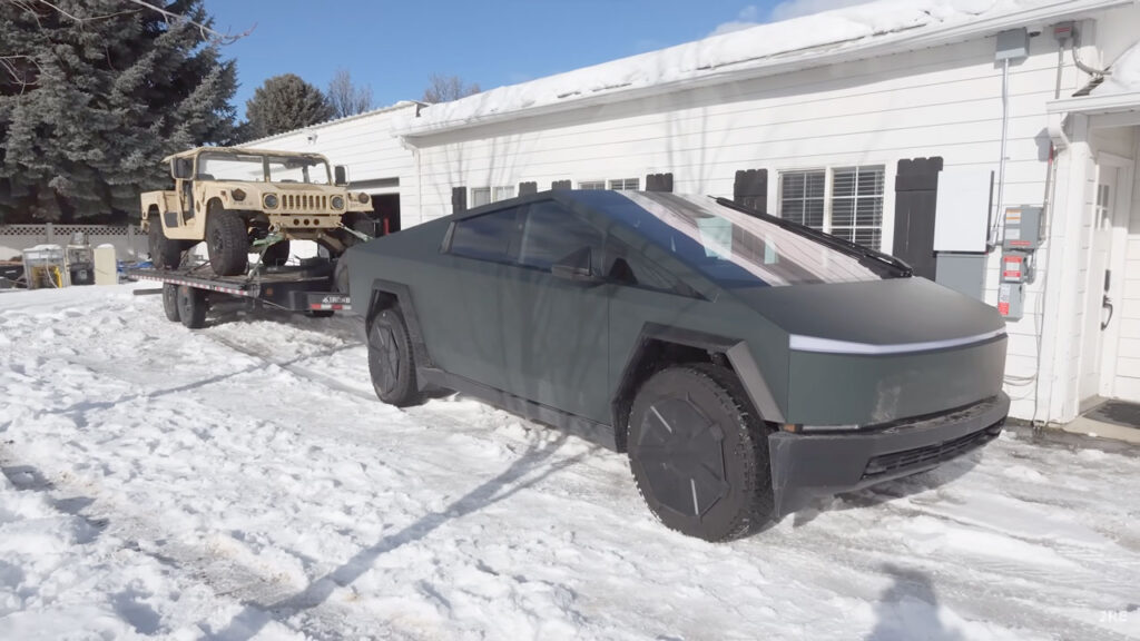 Tesla Cybertruck attached with an 11,000 lbs trailer + Humvee for a range test in freezing cold weather conditions.