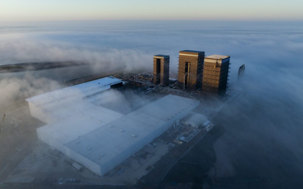 Aerial drone picture of SpaceX Starbase, Texas showing the construction progress of Starfactory expansion.