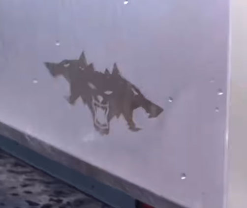 The 3-headed wolf Cyberbeast logo imprinted on the bottom-right of the Tri-Motor Cybertruck's tailgate.