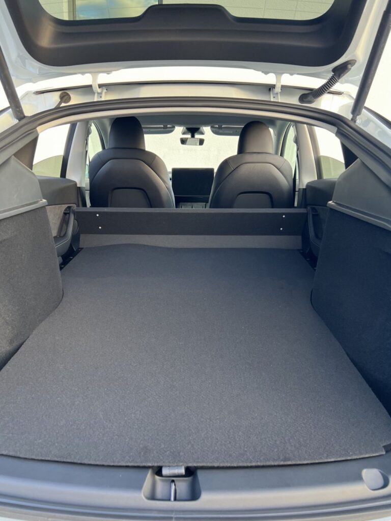 Large flatbed storage space of the 2-seat Tesla Model Y for commercial use in France.
