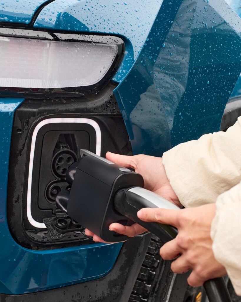 The Rivian NACS adapter enables Tesla Supercharger access on Rivian R1T and R1S vehicles.
