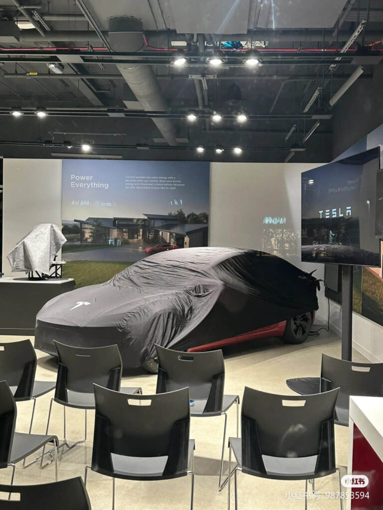 A Tesla Model 3 Ludicrous inside a conference room of a Tesla Showroom in California.