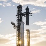 SpaceX launch tower Chopsticks lift the Flight 10 Starship upper stage to mount it onto the Super Heavy rocket booster at the Starbase, Texas launch site.