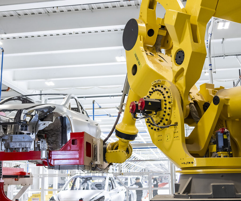 A FANUC robot performing its operation on the car assembly line at a Tesla Gigafactory.