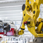 A FANUC robot performing its operation on the car assembly line at a Tesla Gigafactory.