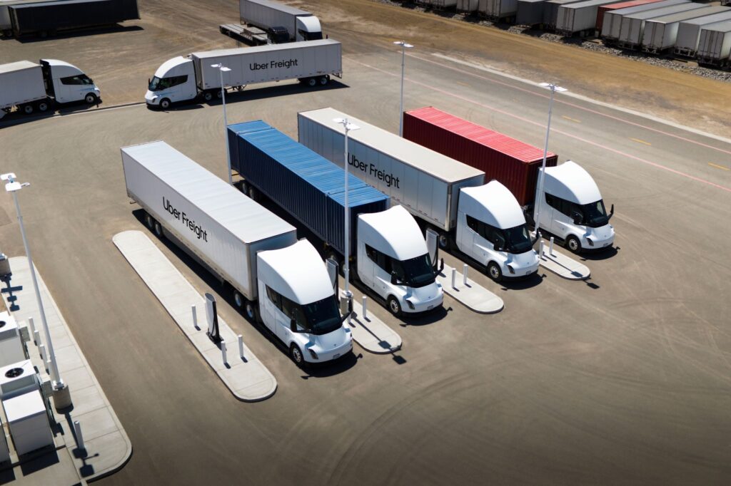 Uber Freight's Tesla Semi fleet as four trucks recharge at a Megacharger station.