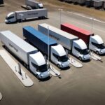 Uber Freight's Tesla Semi fleet as four trucks recharge at a Megacharger station.
