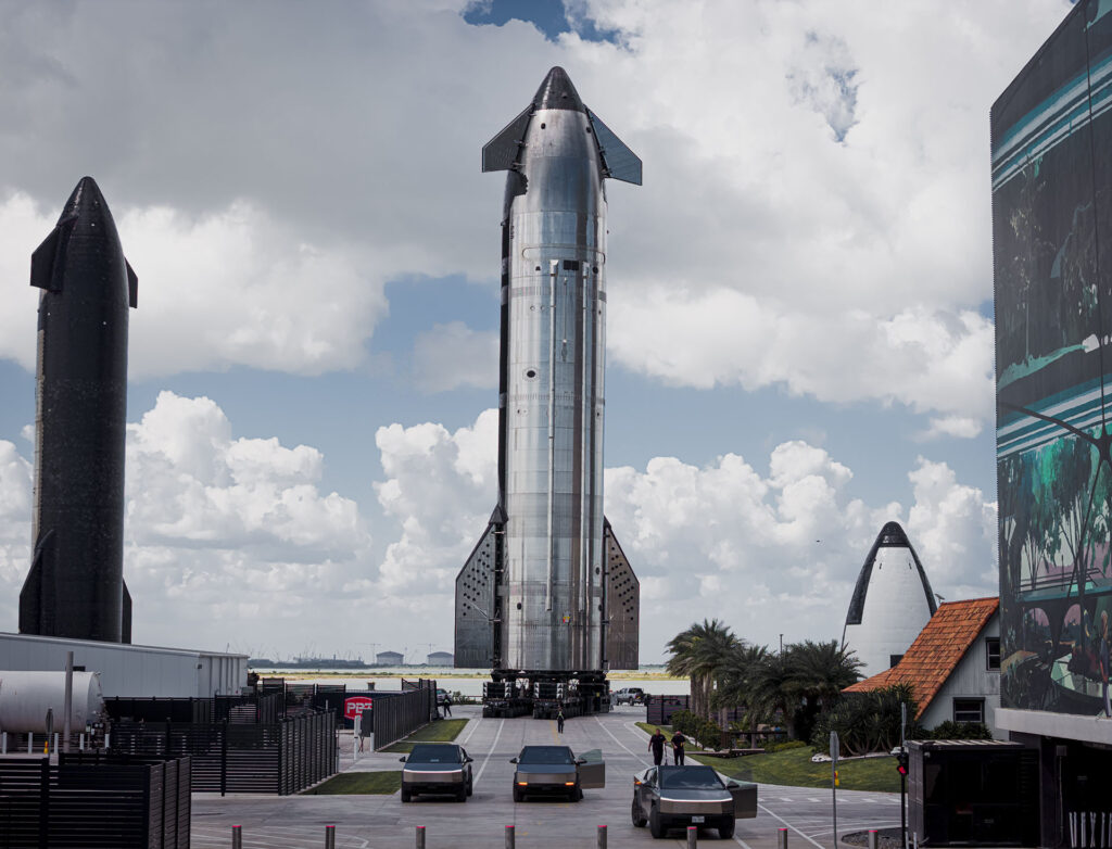 An epic view of Flight 11 Starship 38 (upper stage) moved to the launch pad at Starbase. The humongous spacecraft is led by a trio of Tesla Cybertruck pickup trucks.