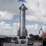 An epic view of Flight 11 Starship 38 (upper stage) moved to the launch pad at Starbase. The humongous spacecraft is led by a trio of Tesla Cybertruck pickup trucks.