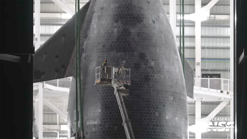SpaceX engineers and workers inspecting Flight 11 Starship 38 heat shield tiles for flight-readiness.