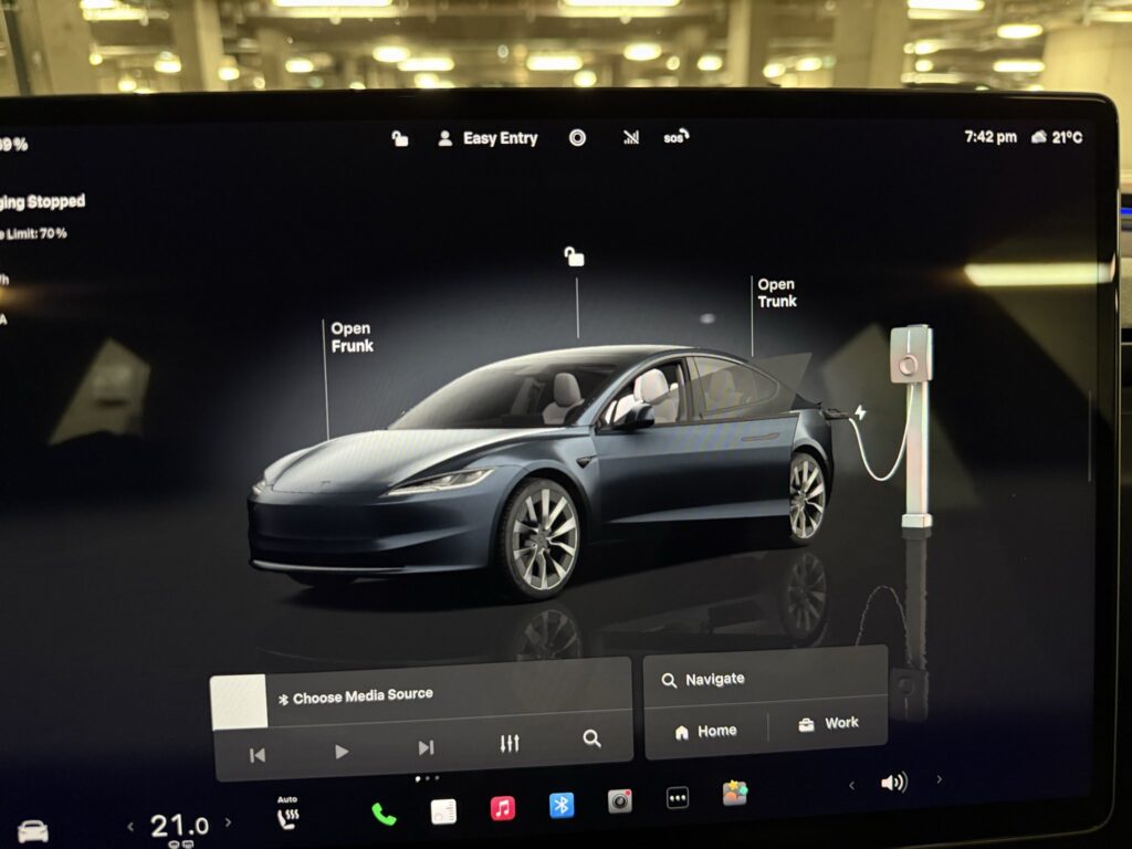 Tesla on-screen visualization shows a third-party charger is connected to the Tesla electric vehicle. Grey cable shows charging has either stopped or not started yet (requires Tesla OTA update 2025.38 or later).