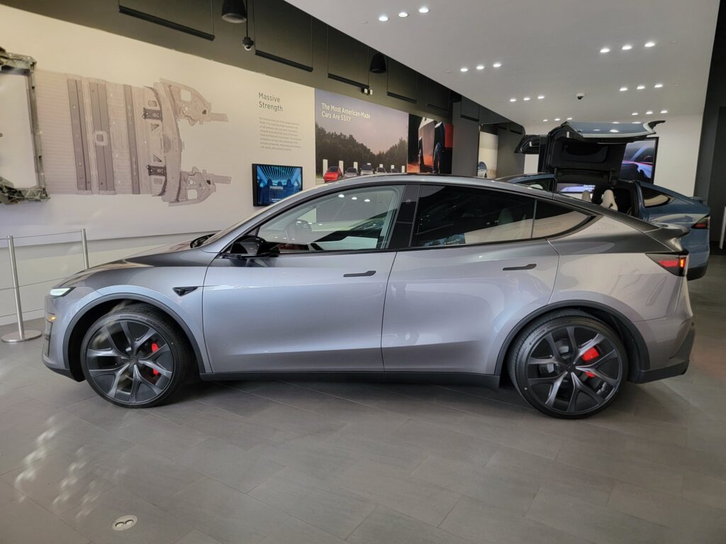 Side profile of the new Tesla Model Y Performance in Quicksilver color on display at the Walnut Creek, California Tesla showroom.