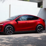Tesla Model Y Performance in Ultra Red charging at home.