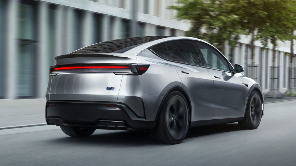 The rear fascia and side profile view of the 2026 Tesla Model Y Performance in Quicksilver color.