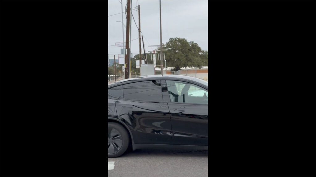 A black Tesla Robotaxi (Model Y Juniper) spotted without any human inside in Austin, Texas.