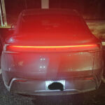 A Tesla Model Y Juniper with its rear glowing light bar. The vehicle was pulled over by a cop in Indiana.