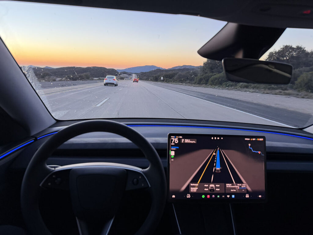 Tesla owner testing FSD v14.2.2.3 (2025.45.8) in a Model Y (Autopilot visualizations visible on the car's center screen).