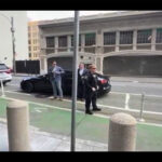 A decoy Tesla Model S and security personnel fool the media into thinking Elon Musk is here, but he arrives at the court in another vehicle.