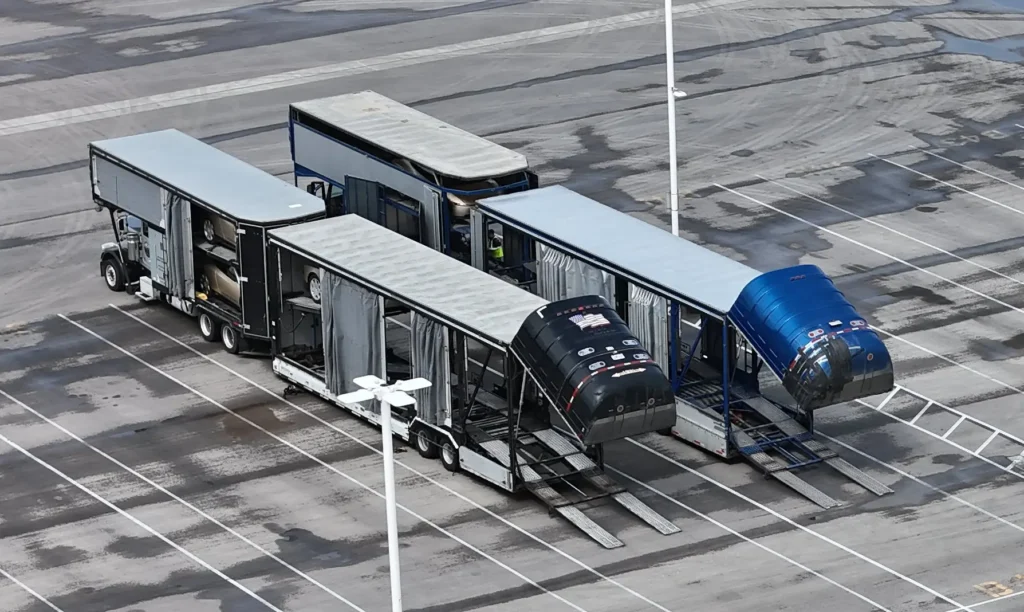 Specially designed covered car carrier trailers for Cybercab transport.