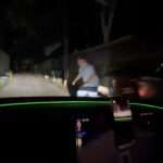 Tesla owner and his friend test the improved reaction time of FSD v14.3 by jumping in front of the vehicle from a dark spot on the side of the road.