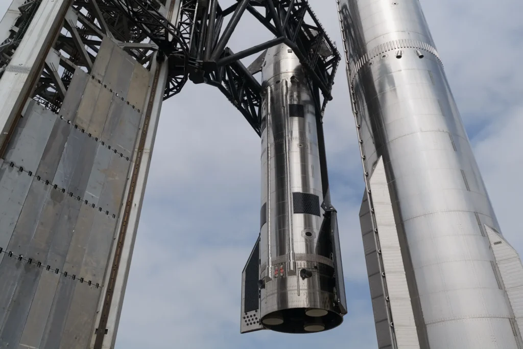 Starship launch tower on Pad 2 Chopsticks lifting the upper stage Ship 39 to mount it on the Super Heavy Booster 19 in preparation for the Flight 12 launch and landing test (IFT-12).
