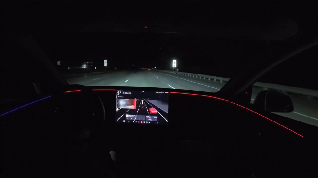 A Tesla vehicle's accent lights show blind spot warning by turning red (left or right). Feature introduced in the 2026 Spring Update (2026.14 and later).