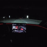 A Tesla vehicle's accent lights show blind spot warning by turning red (left or right). Feature introduced in the 2026 Spring Update (2026.14 and later).