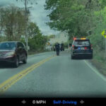 Tesla FSD v14 recognizes hand gestures of the police officer and moves only when he permits.