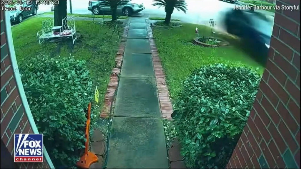 Screenshot of the CCTV camera footage showing a Tesla crashing into a Texas home at a high speed.