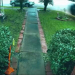 Screenshot of the CCTV camera footage showing a Tesla crashing into a Texas home at a high speed.