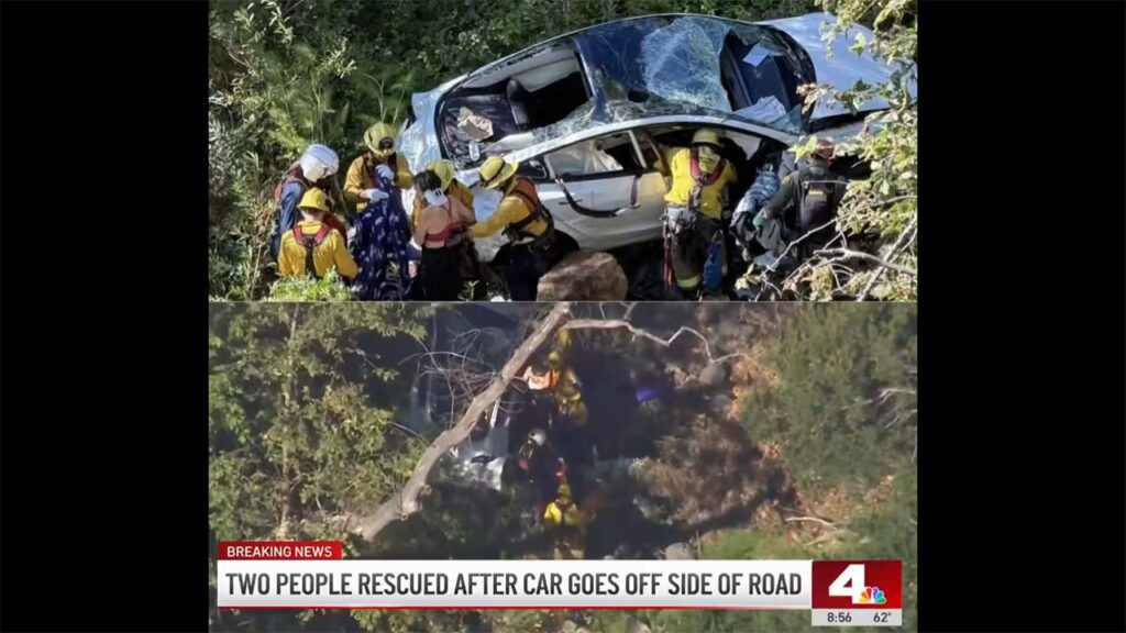 The fallen Tesla Model 3 as firefighters rescue the couple from a cliff depth of 300 feet on the side of the Mulholland Highway in Malibu, California.