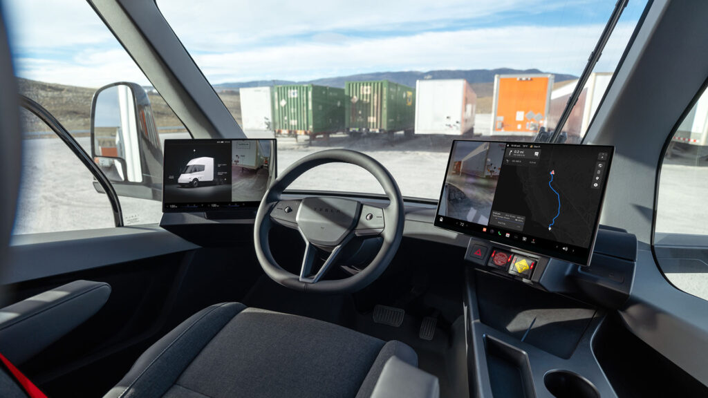 The cabin design of the new Tesla Semi with the steering wheel in the center and two screens (one on each side).