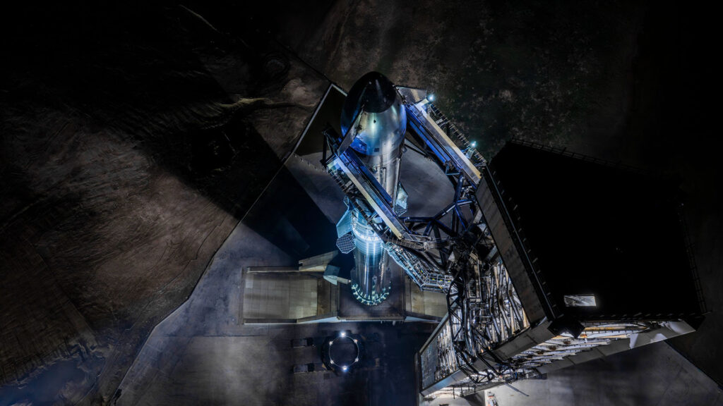 Aerial view of the fully stacked Flight 13 Starship mounted on Pad 2 OLM at the Mechazilla launch tower, Starbase, Texas.