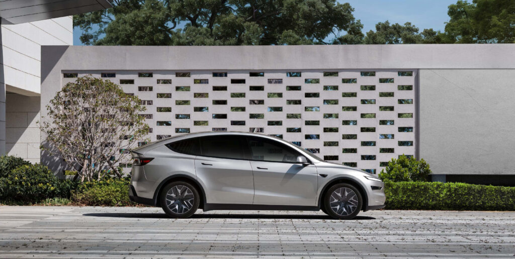Tesla Model Y L in Cosmic Silver color parked in a contemporary setting.