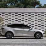 Tesla Model Y L in Cosmic Silver color parked in a contemporary setting.