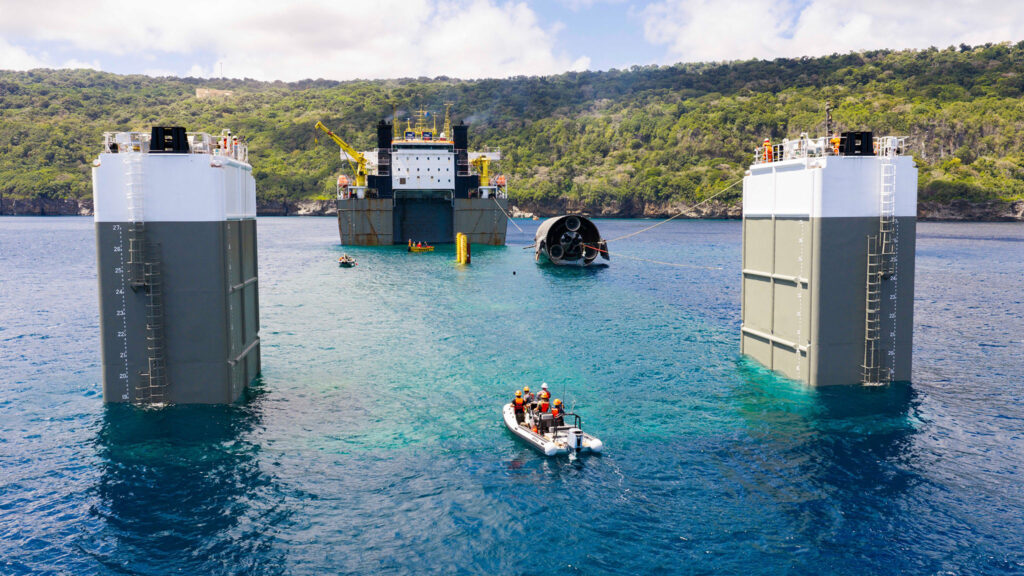 SpaceX engineers and marine crew guiding Starship 40 onto the semi-submersible vessel Forte for its return to Starbase, TX, US.
