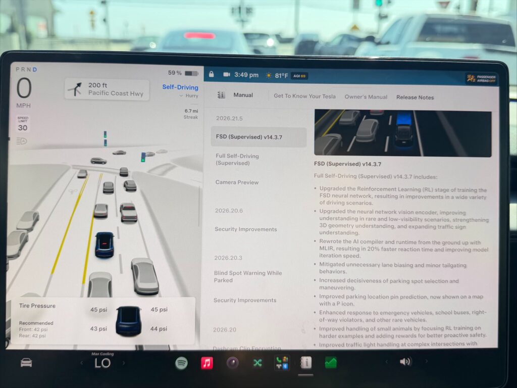 Tesla FSD v14.3.7 (2026.21.5) driving visualization and release notes screen.