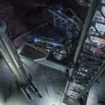Aerial view of the Flight 14 Starship Super Heavy Booster 21 (left) and the Starbase Pad 2 launch tower (right).