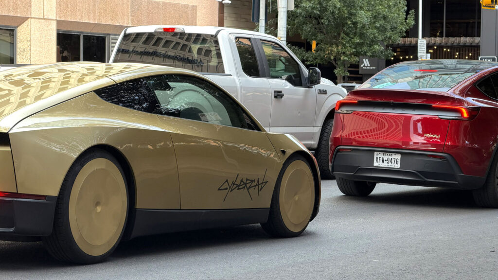 A red Tesla Model Y Robotaxi leads a Cybercab on the streets of Austin, Texas.