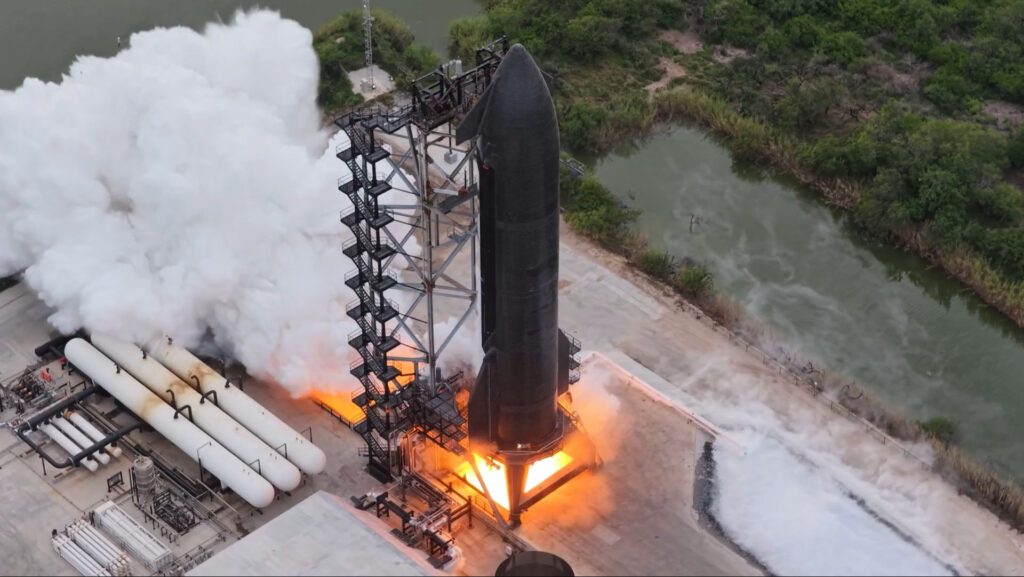 Aerial view of Flight 15 Starship 42 as it performs a six-engine static fire test at the Massey's Outpost, Starbase, Texas.