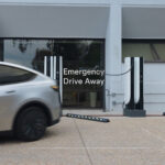 A Tesla Model Y leaves the Supercharger while plugged in using the Emergency Drive Away feature (software update version 2026.38.3 or later, video above).