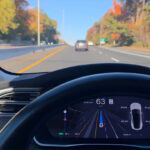 Tesla FSD v14.3 Lite (2026.38.5.11) running on a legacy Model S (driving visualizations on the instrument panel screen).